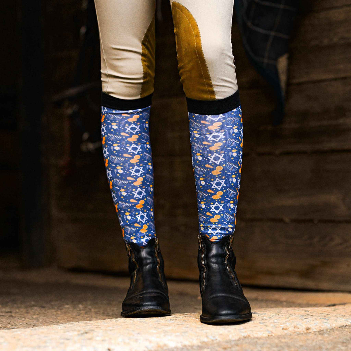 Blue Keep Calm & Dreidel On riding socks with Hanukkah symbols worn with black riding boots