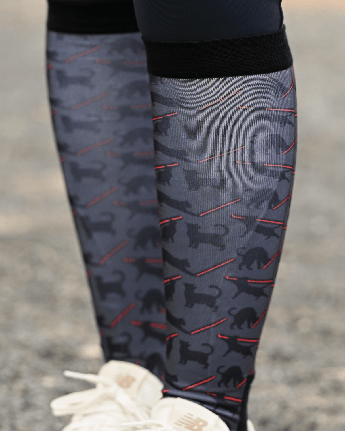 Close crop of the Laser Cats boot sock print, black cats firing red laser beams on charcoal