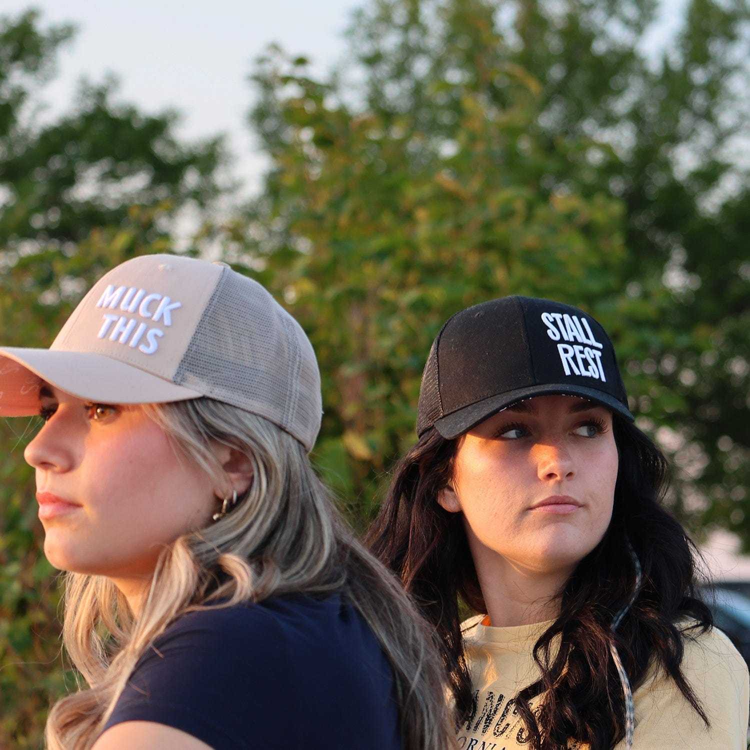 Two women wearing Muck This Equestrian Bundle trucker hats in outdoor setting