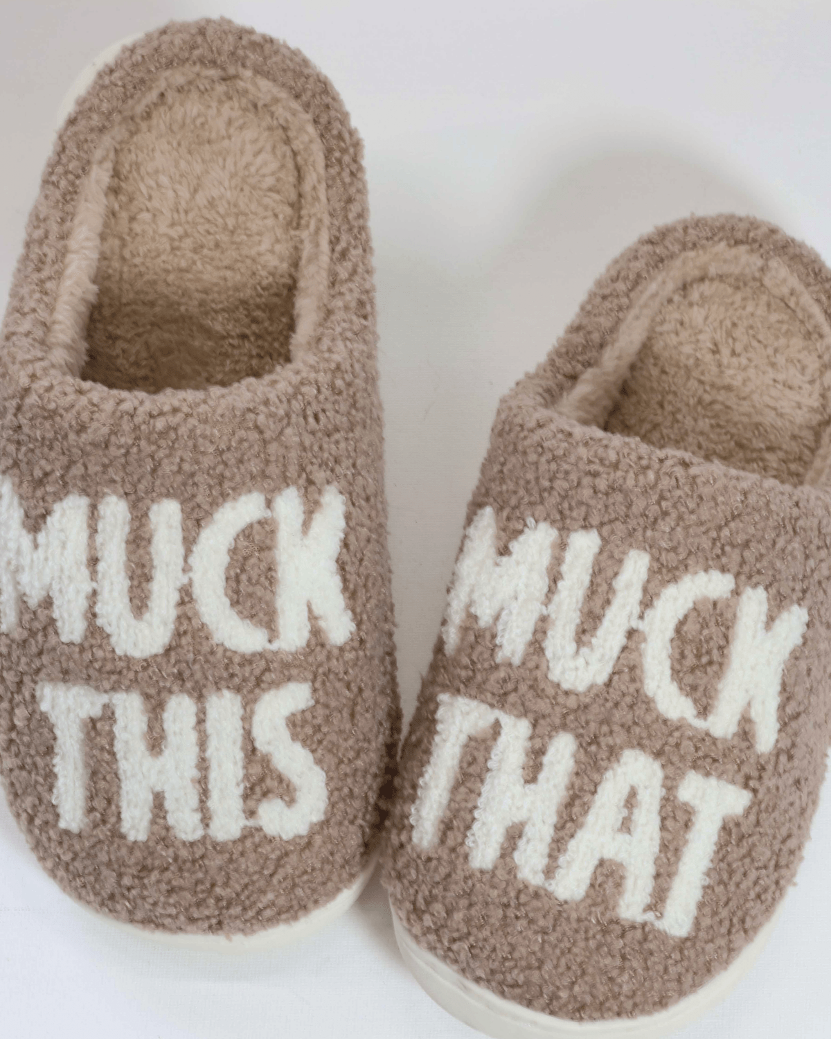 Cozy brown slippers with "MUCK THIS" and "MUCK THAT" text, part of the Muck This Equestrian Bundle