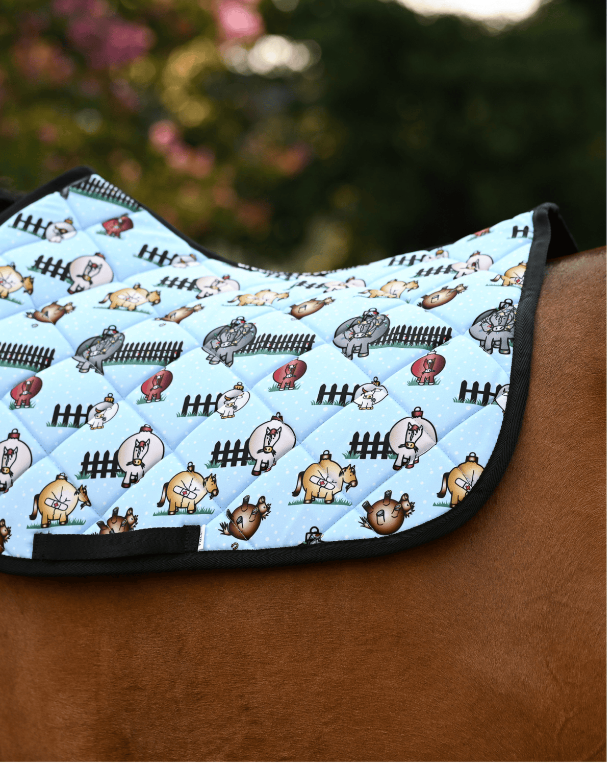 Light blue Pasture Ornaments pad with bauble horses and black picket fences, on a chestnut horse