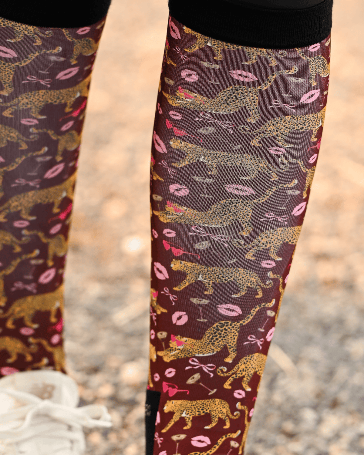 Close crop of the Ready to Play boot sock print, gold leopards, pink lips and bows on burgundy