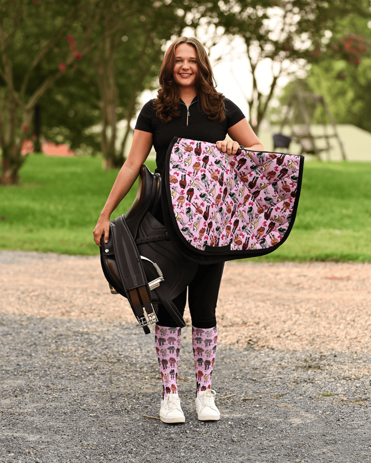 Red Ribbon Girlies all-purpose saddle pad in pink, printed with horse hindquarters tied with red bows