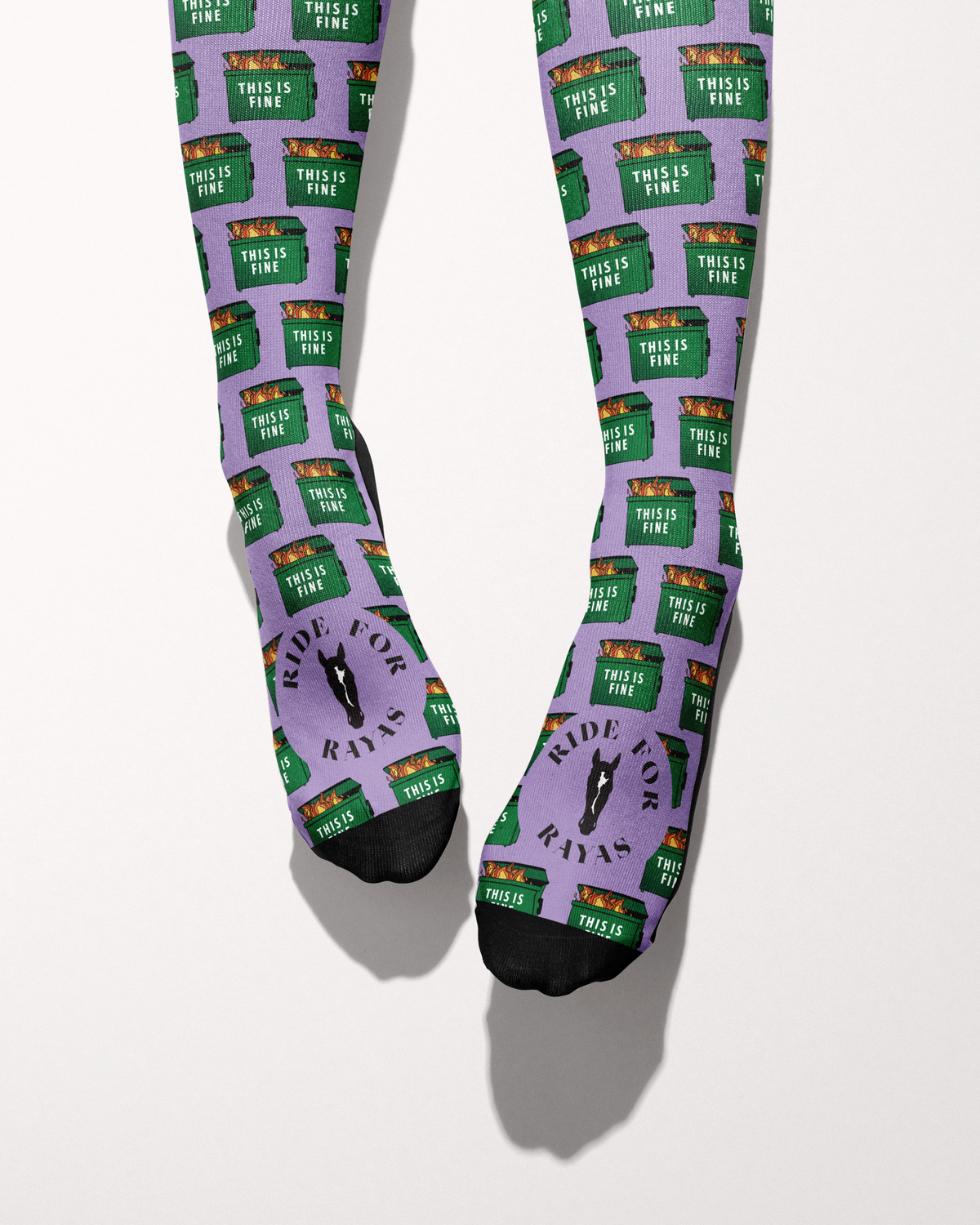 Dumpster Fire socks viewed from the toes, with black toe caps and the Ride for Rayas horse logo on the foot