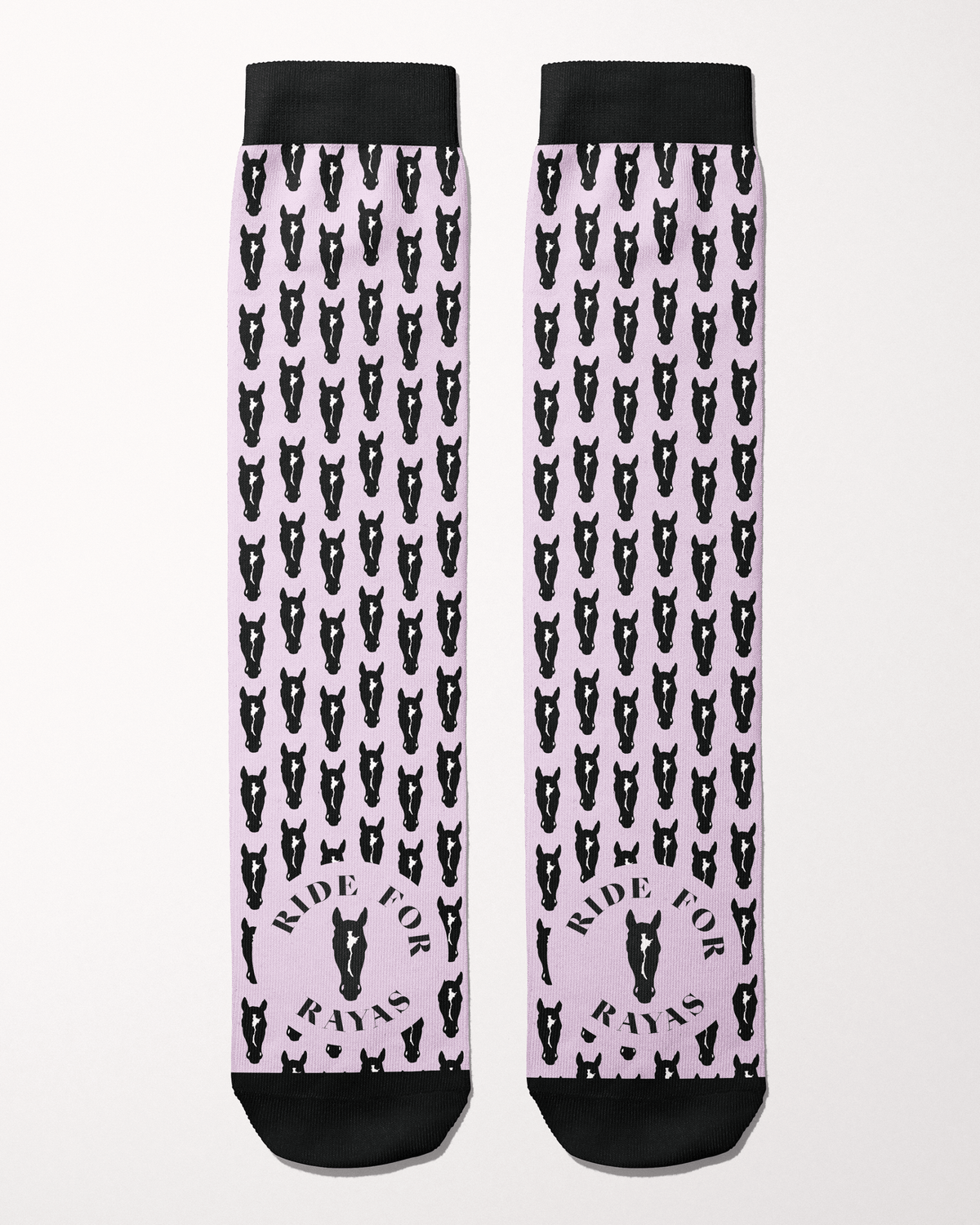Ride for Rayas Nikko equestrian boot socks in pale pink with black horse heads, flat lay of the pair, by Dreamers & Schemers