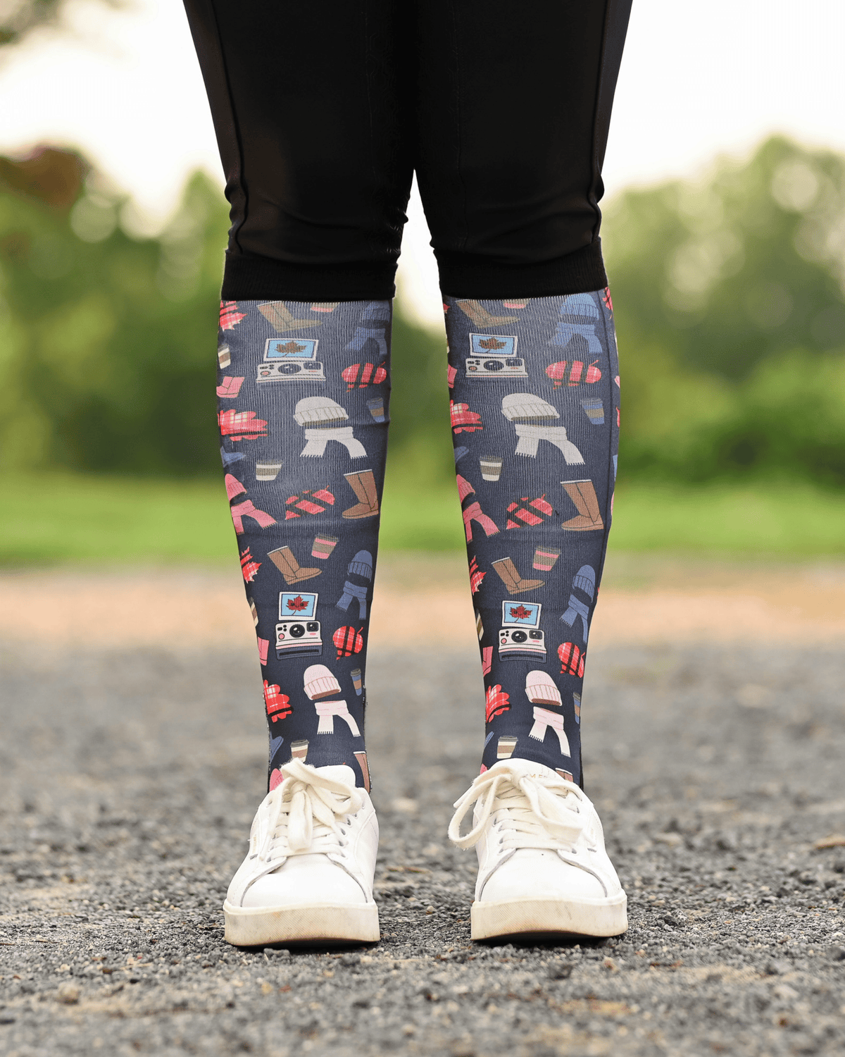 Sept Starter Pack boot socks seen from the front, charcoal ground scattered with autumn boots, plaid, beanies and lattes