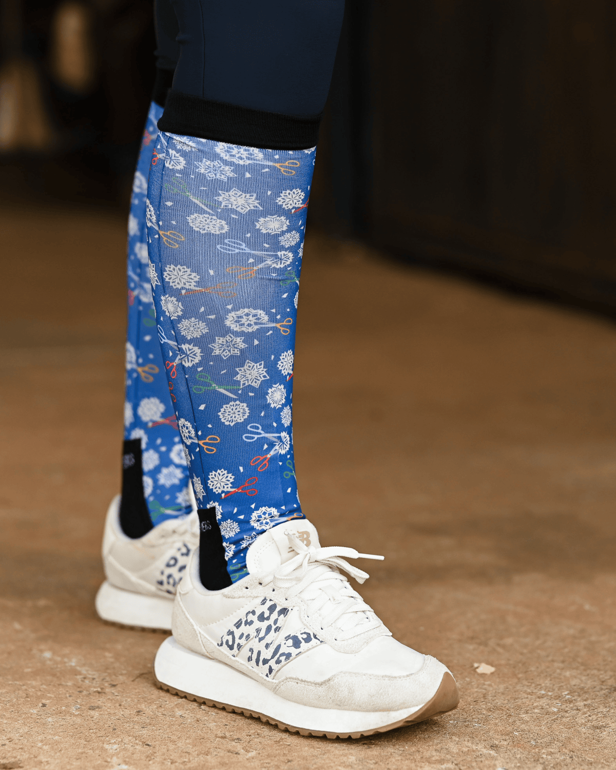 Shear Magic riding boot socks styled over breeches, cobalt blue with white clip rosettes and coloured scissors