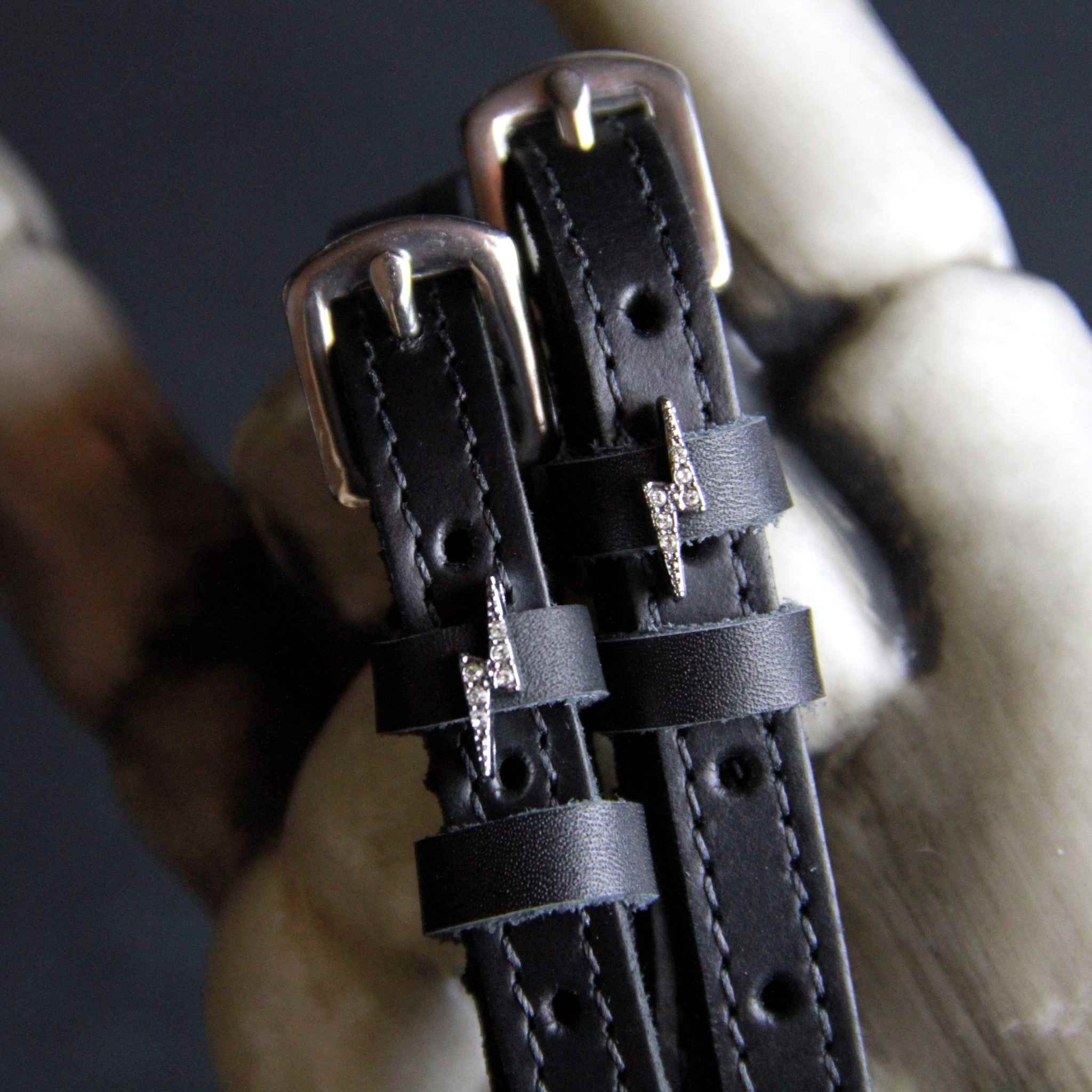 Black leather Silver Bling Bolt Spur Straps with silver bolt charm and stainless steel buckle close-up