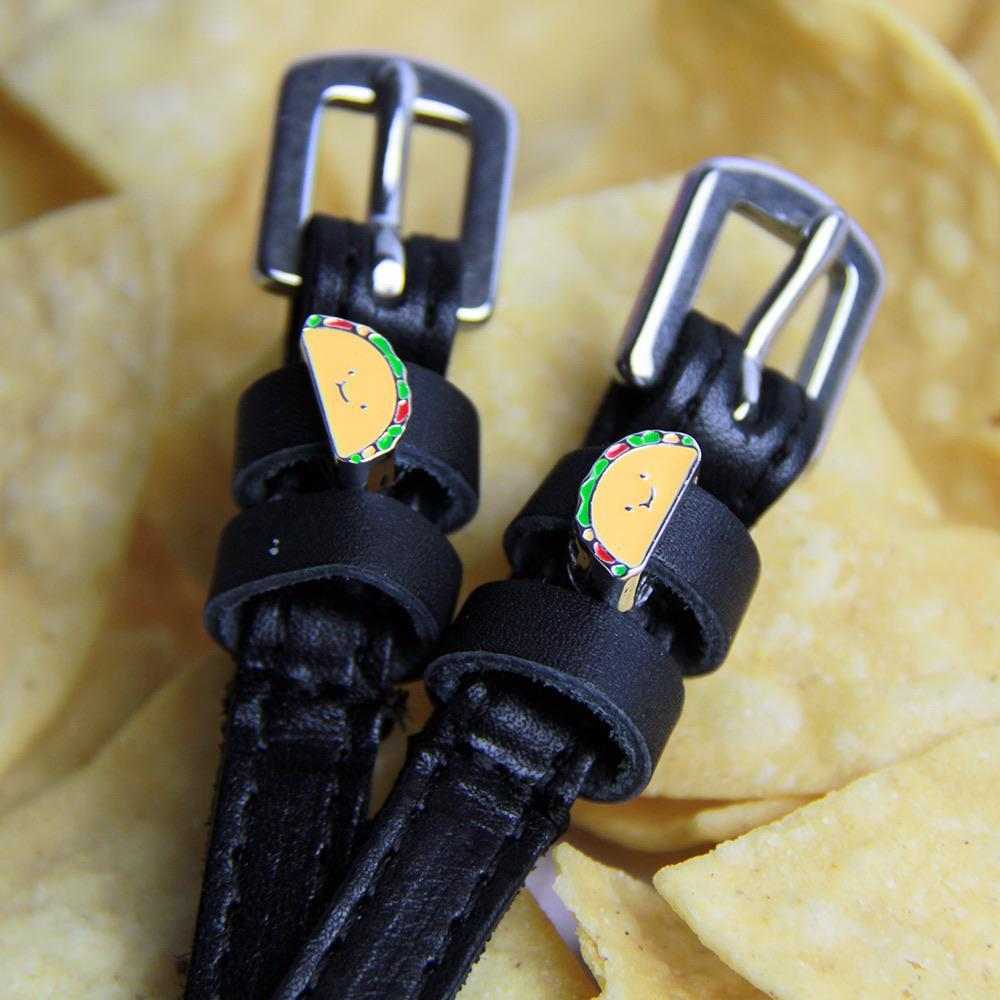 Black leather spur straps with stainless steel buckles and custom taco-themed charms