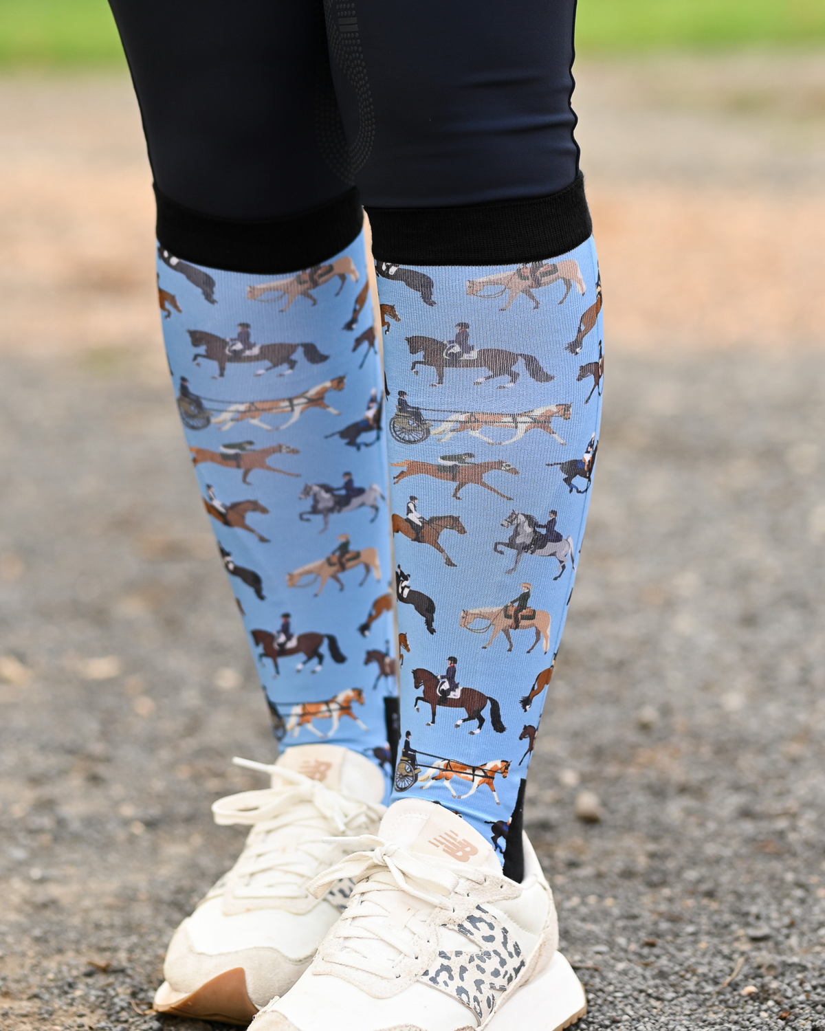 The Pony Island Horse Sports Pair & a Spare boot socks worn on the calf, light blue with riders mounted across every discipline