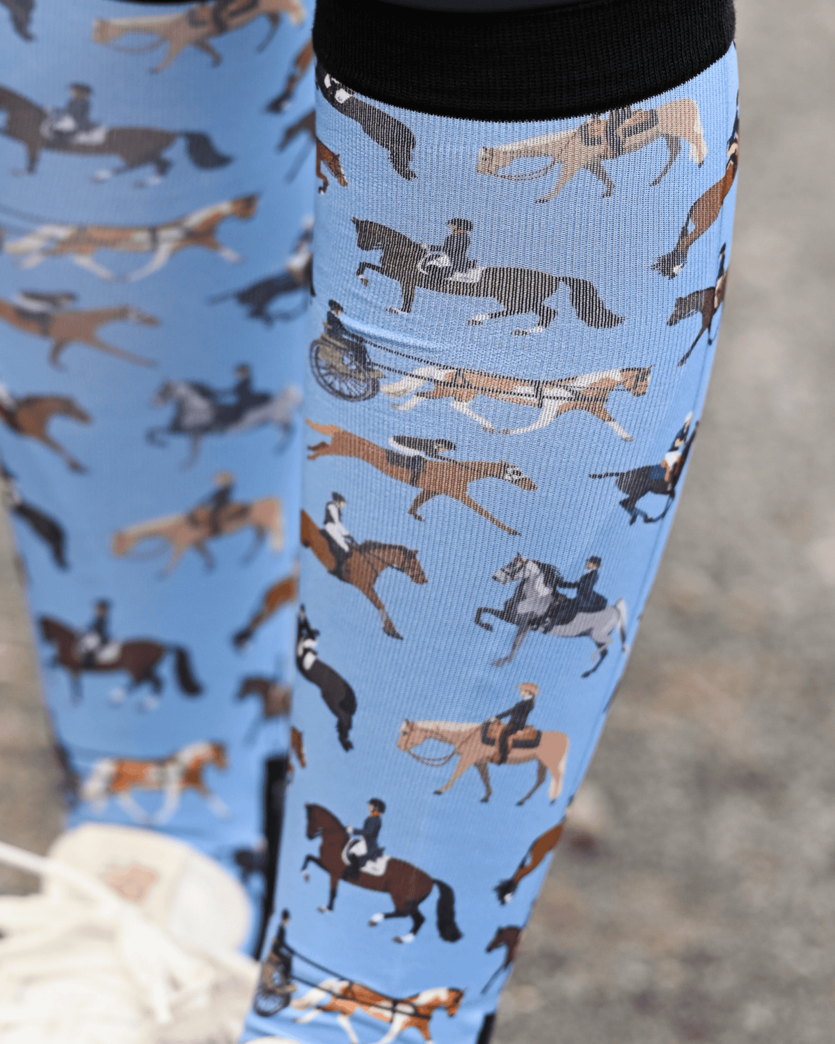 Close crop of the The Pony Island Horse Sports boot sock print, riders mounted across every discipline on light blue