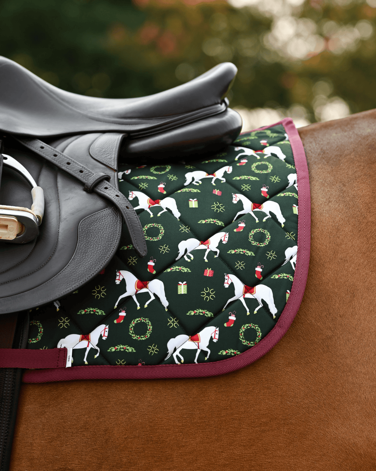 Lippizan Horses holiday pad tacked up on a chestnut horse, white horses and gifts on dark green