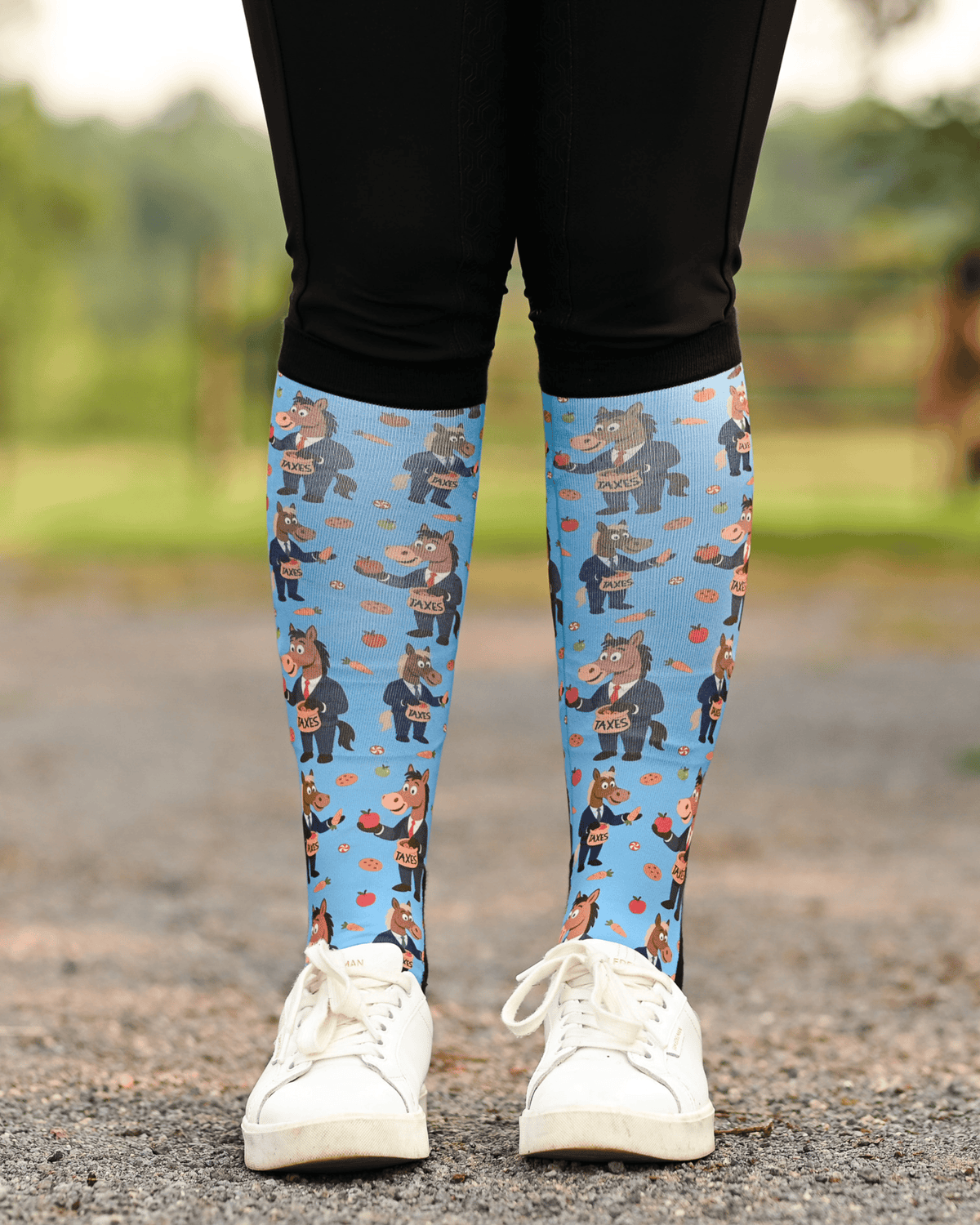 Treat Tax riding boot socks styled over breeches, bright blue with horses in business suits paying the treat tax