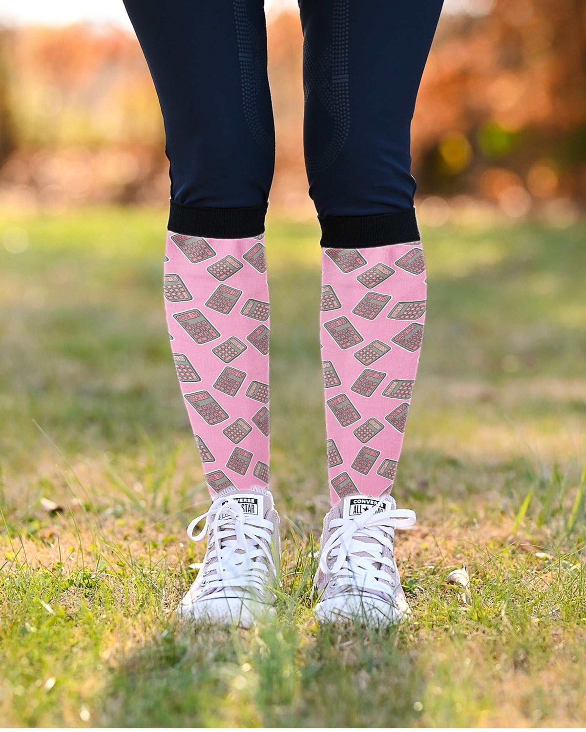 Boobies Limited Edition boot socks, calculator print on pink, worn over navy breeches with white sneakers, by Dreamers & Schemers