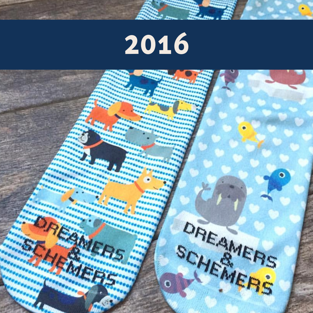 Limited edition 2016 Dog Park boot socks with playful dog illustrations and black cuffs