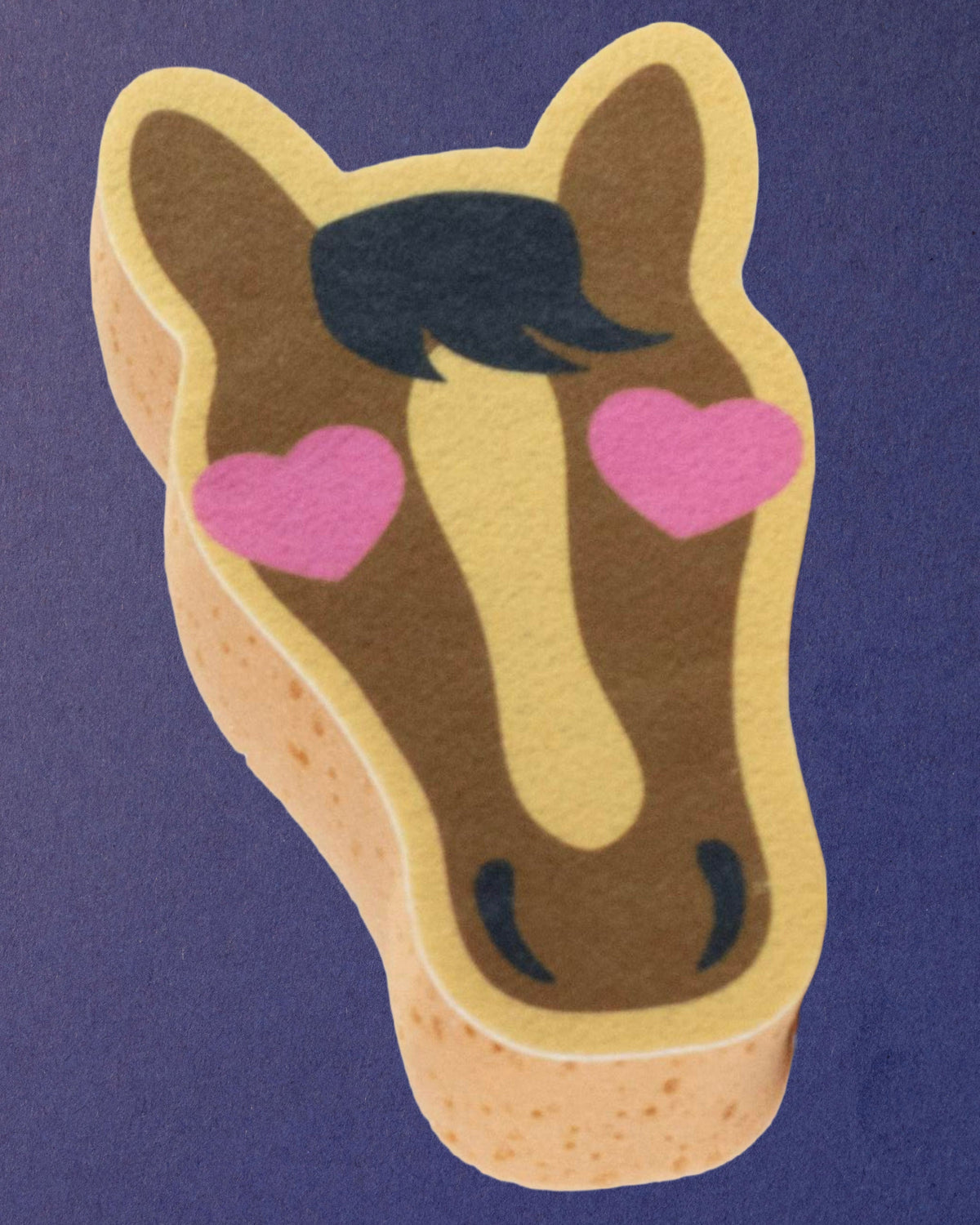 Pony Love expanding horse bath sponge on a navy background, printed side facing up