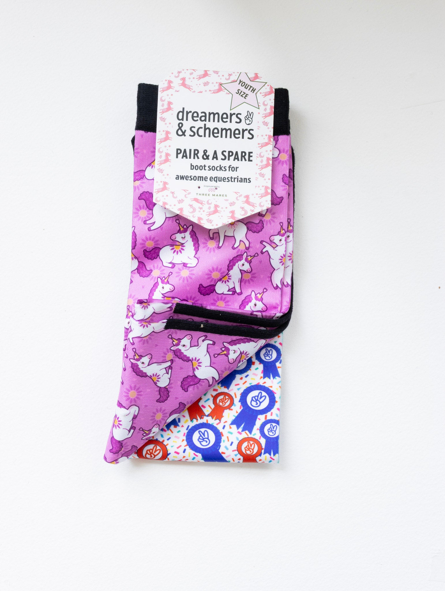 Sunshine and Unicorns youth boot socks shown folded with the included spare sock and patterned cuff