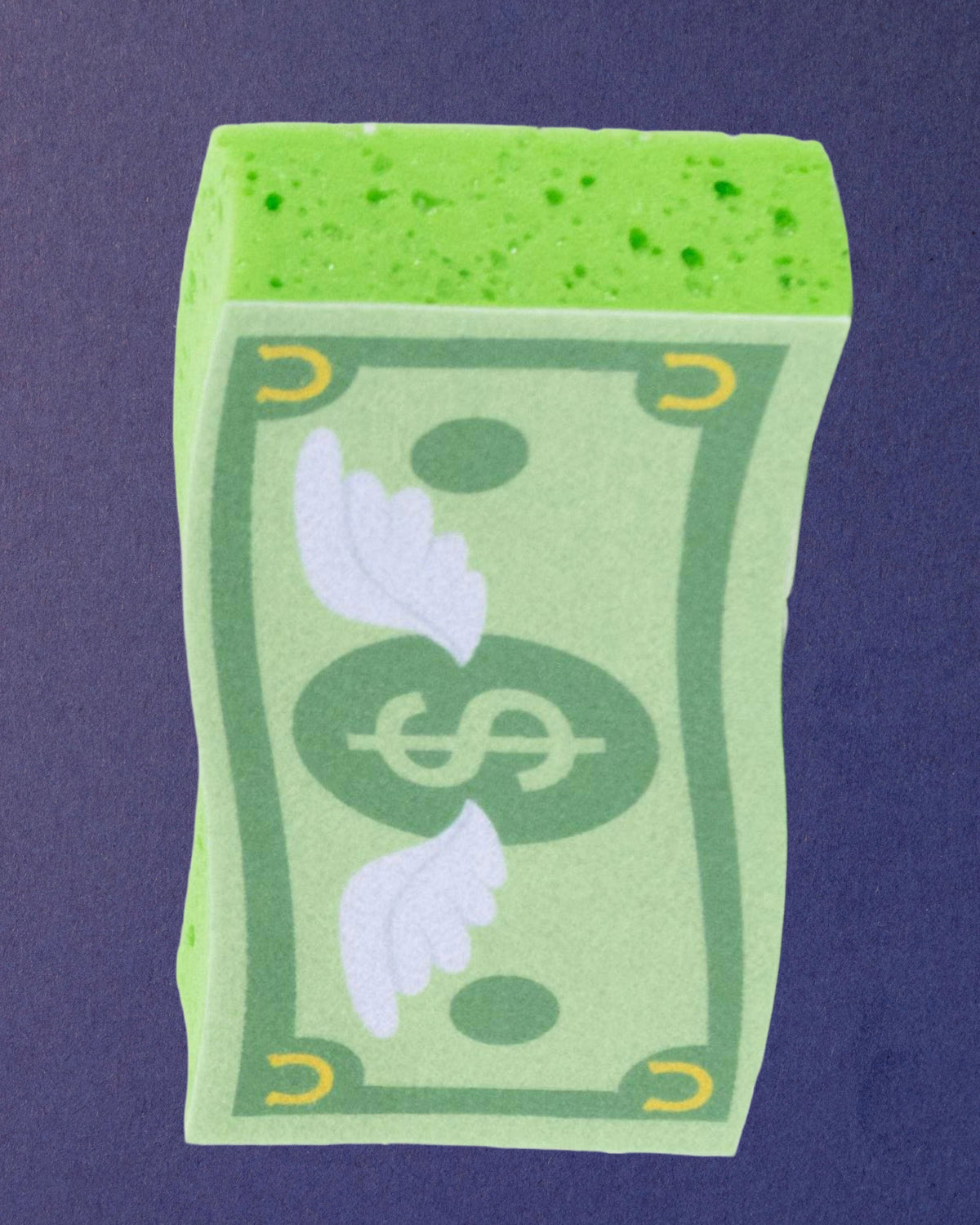 Cash Money expanding bath sponge at an angle so the sponge thickness and textured edge show