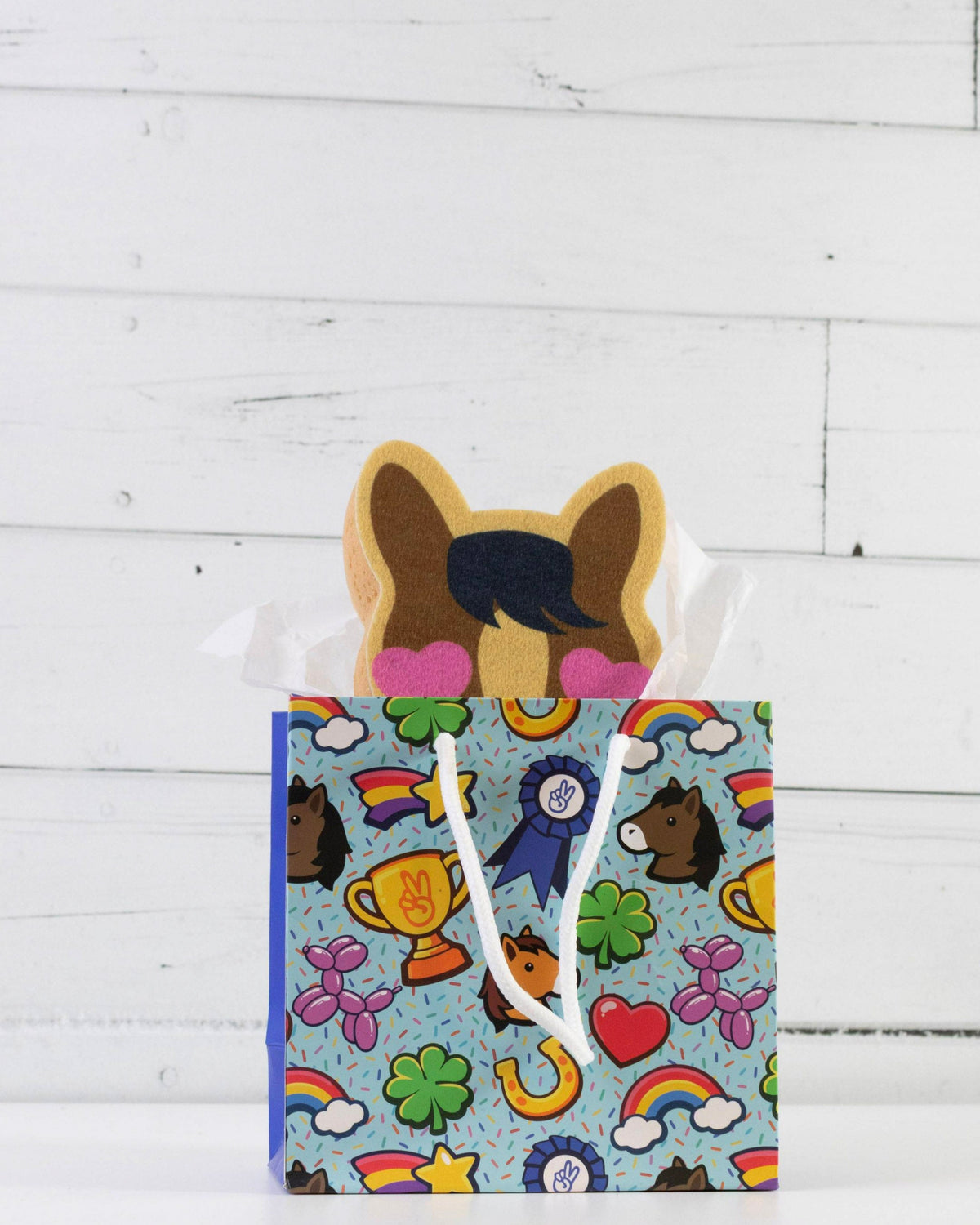 Pony Love bath sponge styled with other Dreamers & Schemers accessories on a white shelf