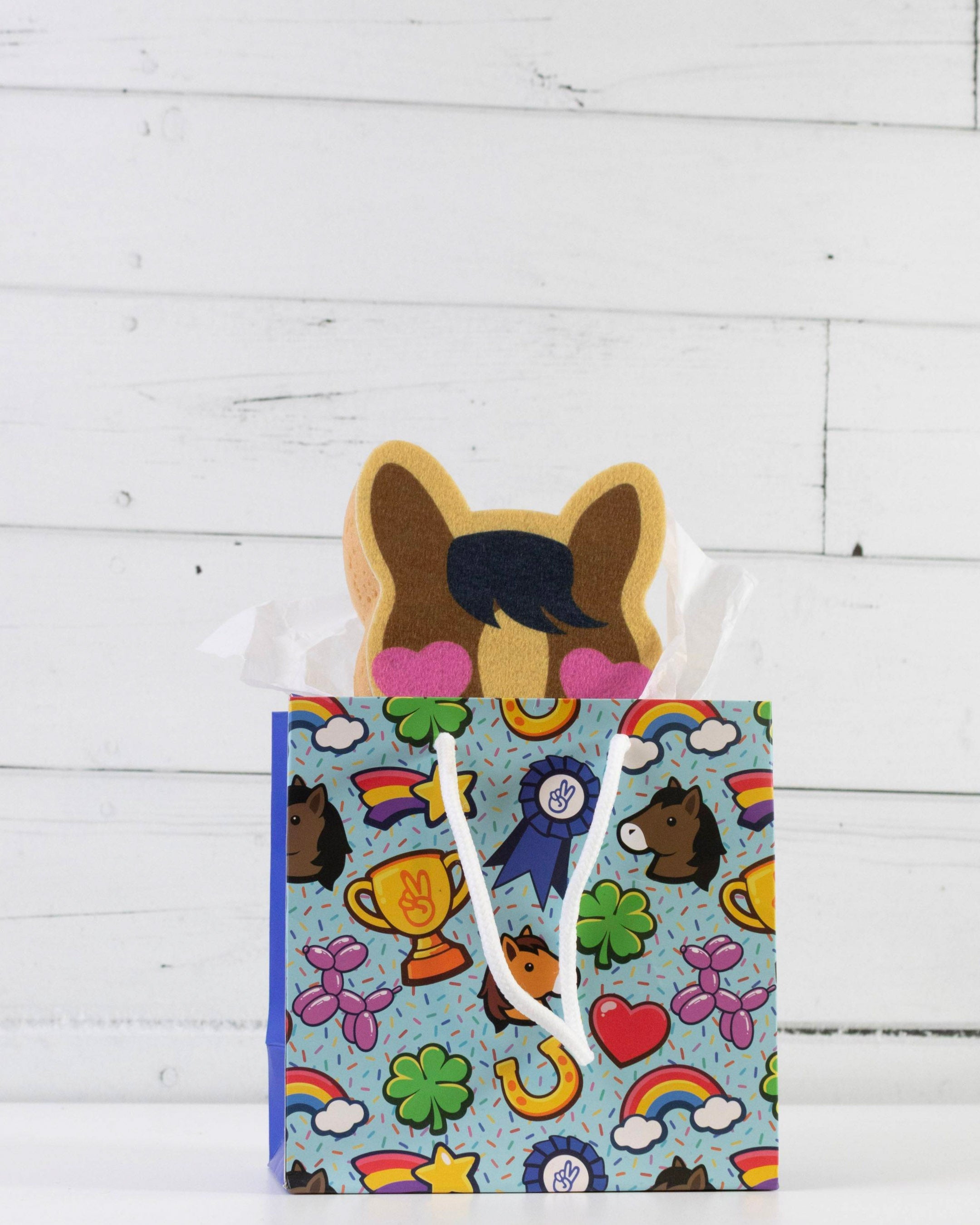 Pony Love bath sponge styled with other Dreamers & Schemers accessories on a white shelf