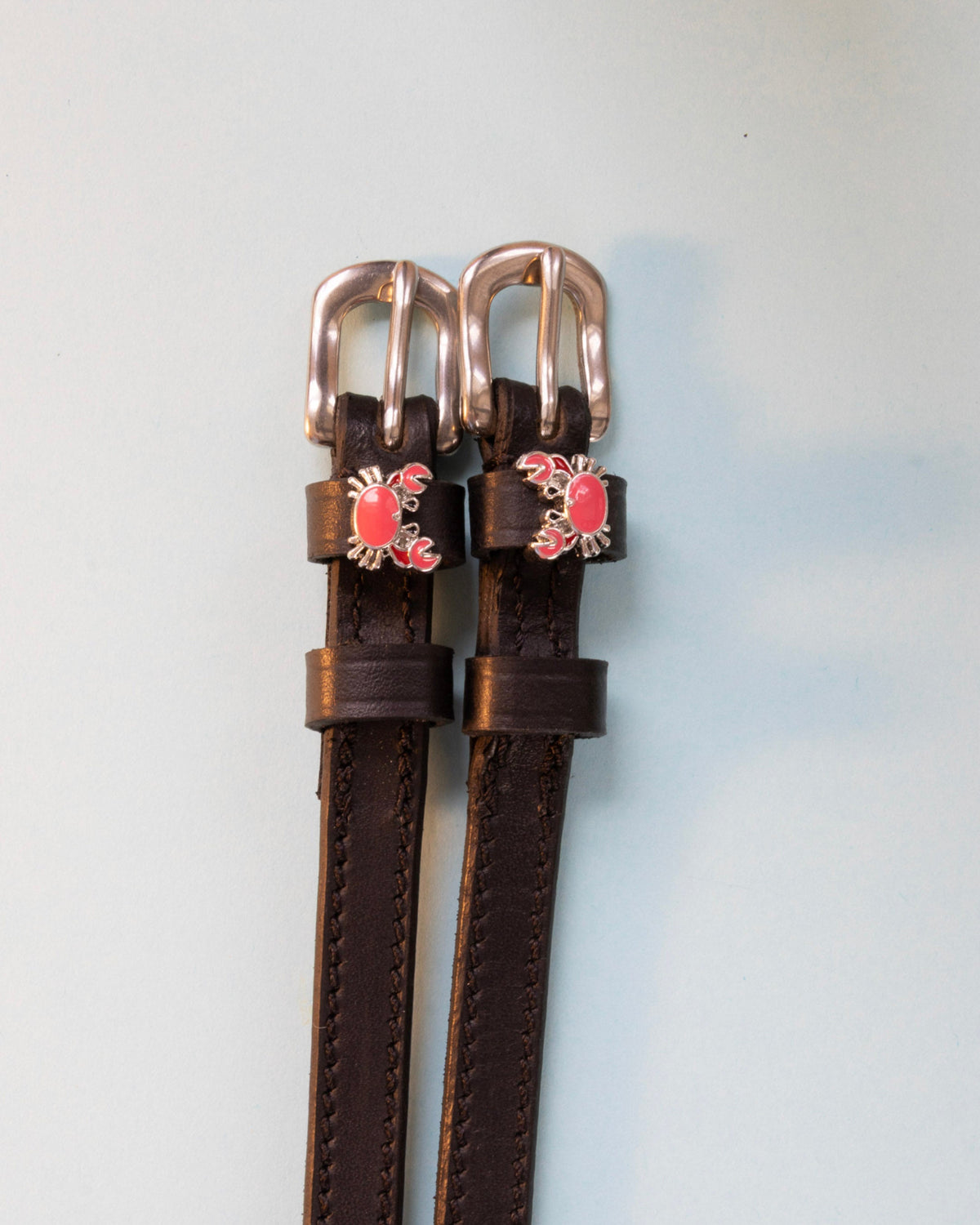 Crabbin' ManeJane spur straps with the signature Crabbin' charm, shown on an off-white background