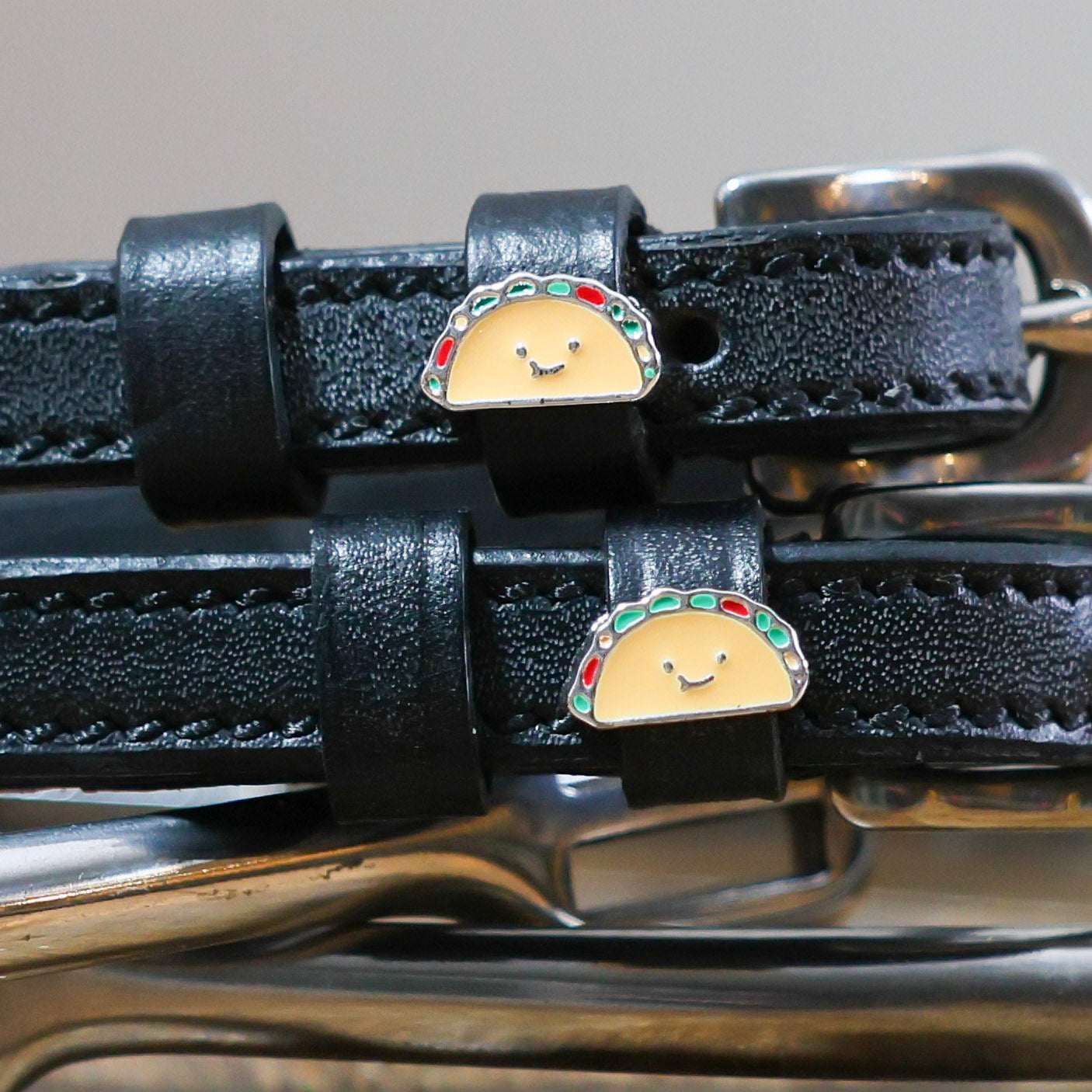 Black leather spur straps with cute taco charms and stainless steel buckles