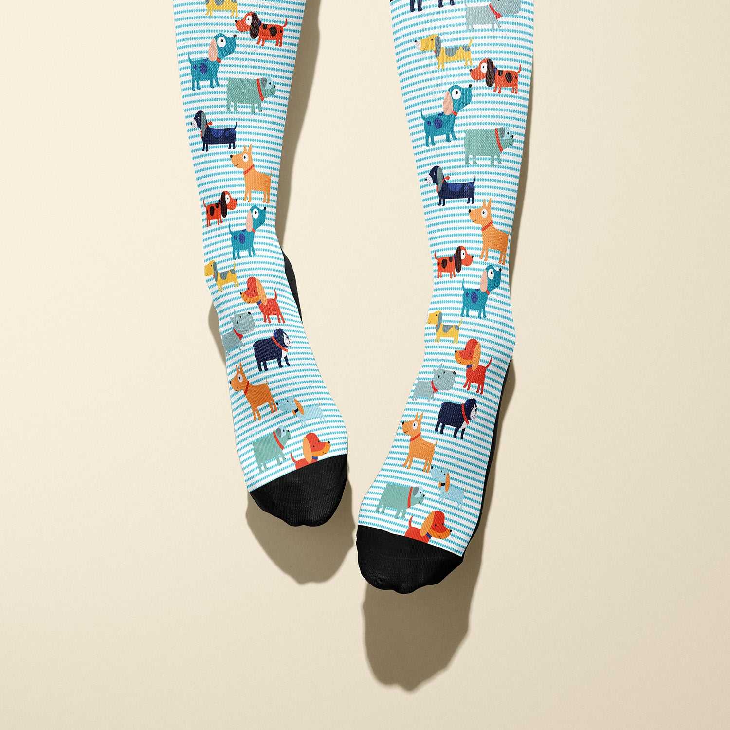 Limited edition Dog Park boot socks featuring playful vector dogs and black cuffs, made in the USA.