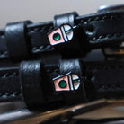 Frappe Spur Straps black leather with custom charm and stainless steel buckle close-up