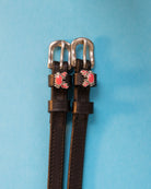 Crabbin' ManeJane spur straps with the signature Crabbin' charm, shown on a light blue background