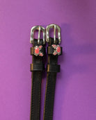 Crabbin' ManeJane spur straps with the signature Crabbin' charm, shown on a purple background