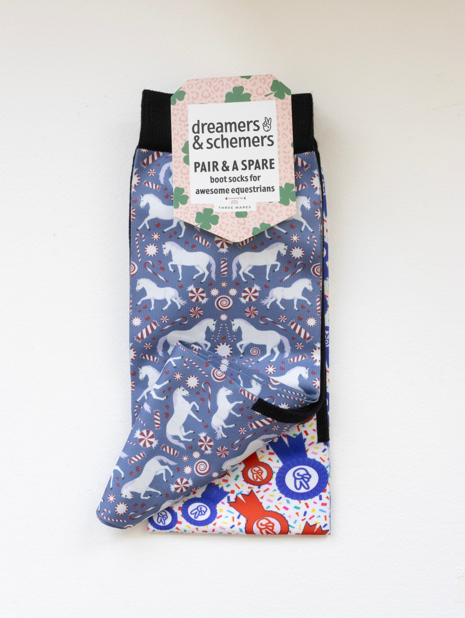 The Pony Island Peppermint Ponies boot socks shown folded with the included spare sock and printed cuff detail