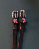 Crabbin' ManeJane spur straps with the signature Crabbin' charm, shown on a charcoal background