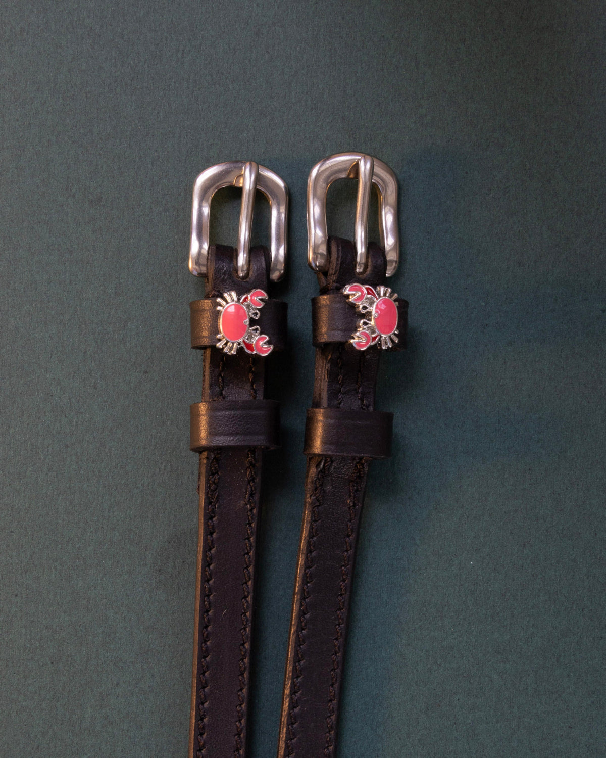 Crabbin' ManeJane spur straps with the signature Crabbin' charm, shown on a charcoal background
