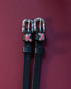 Crabbin' ManeJane spur straps with the signature Crabbin' charm, shown on a plum background