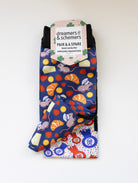 Merci boot socks shown folded with the included spare sock and printed cuff detail