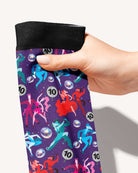 Prancing with the Stars Limited Edition boot socks, dancing couples and disco balls on deep purple, held in hand, close-up of the print, by Dreamers & Schemers
