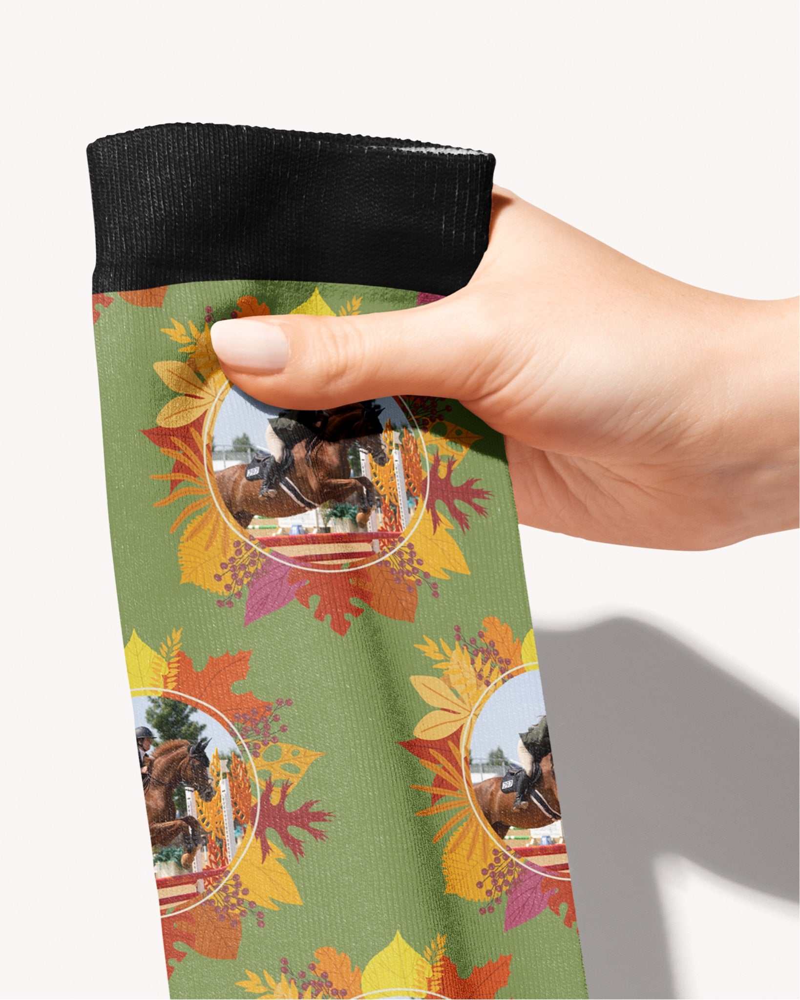 Autumn Leaves custom photo equestrian boot socks, held in hand, close-up of the autumn-leaf wreath pattern, by Dreamers & Schemers
