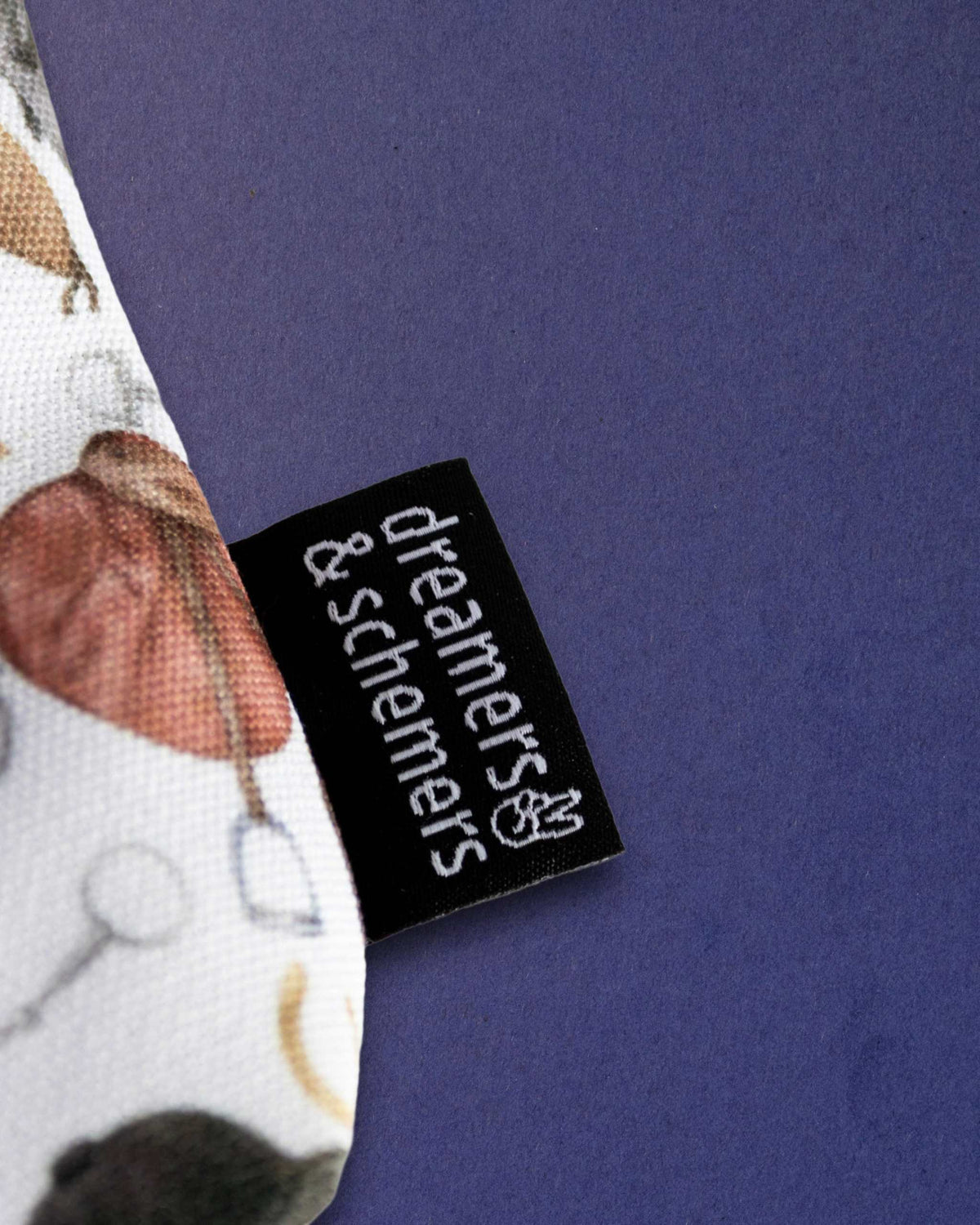 Woven dreamers & schemers label stitched into the seam of The Hunt pouch, saddle print behind