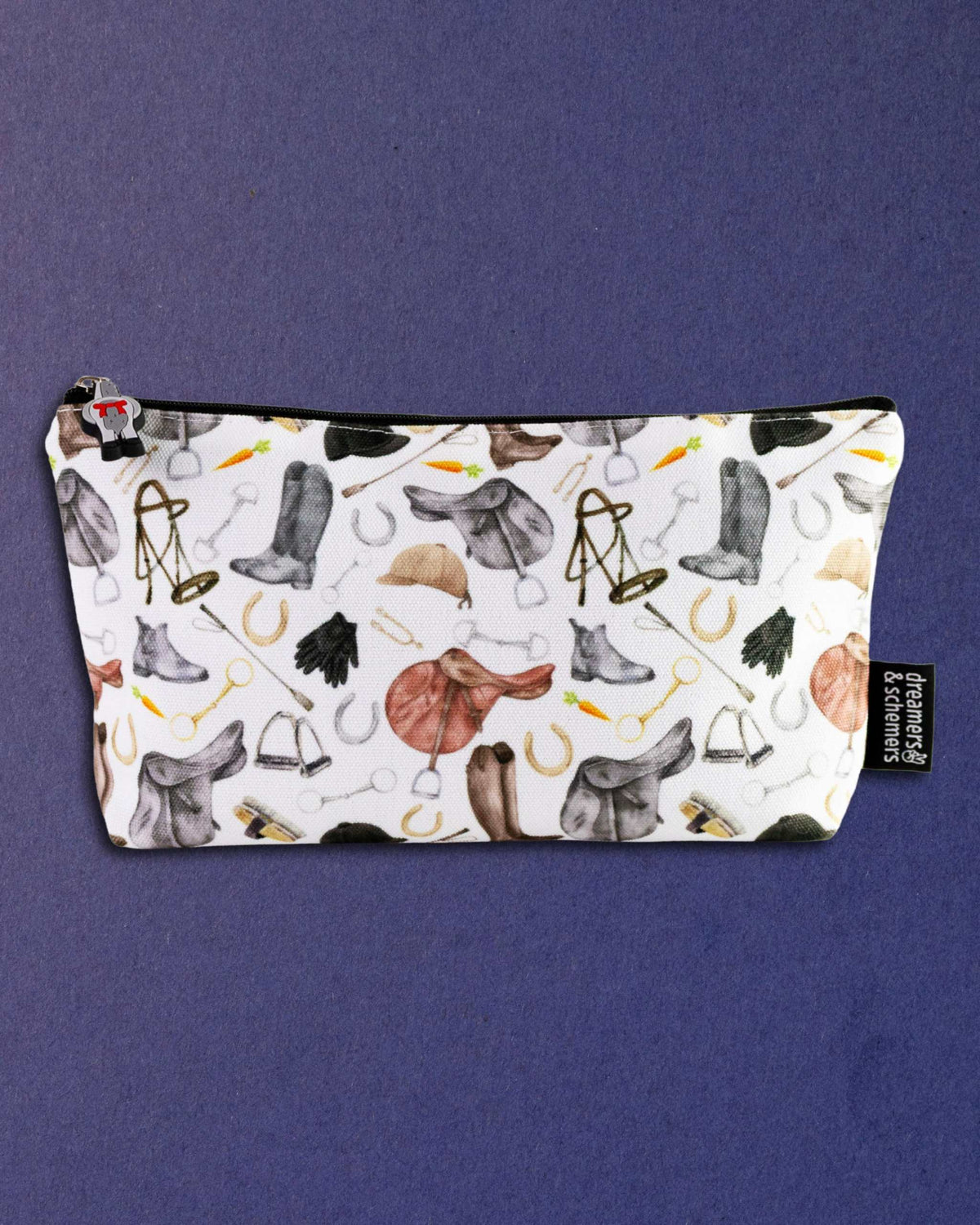 The Hunt zip pouch photographed flat, showing the full spread of hunt-field tack across the canvas