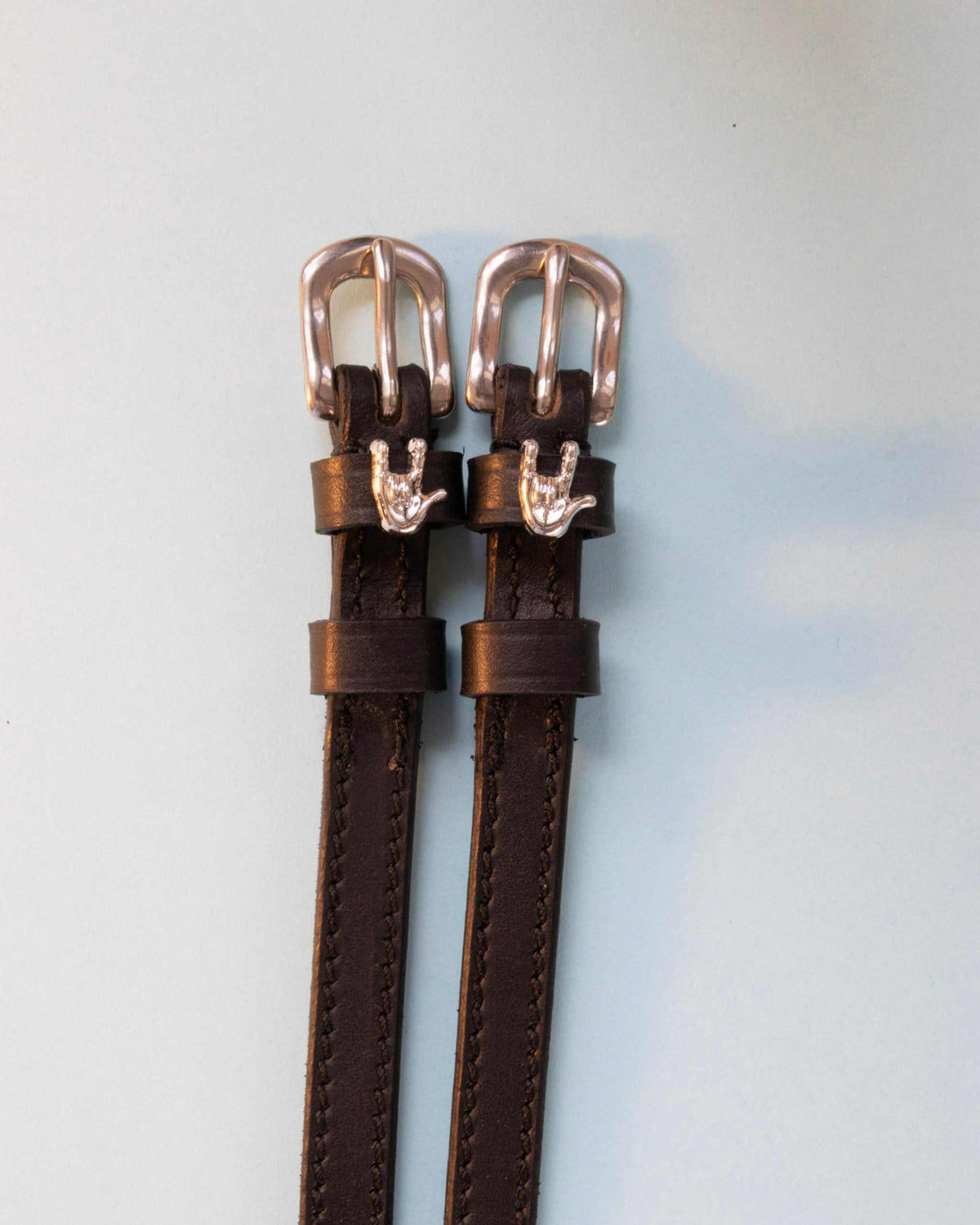 Rock On ManeJane spur straps with the signature Rock On charm, shown on an off-white background