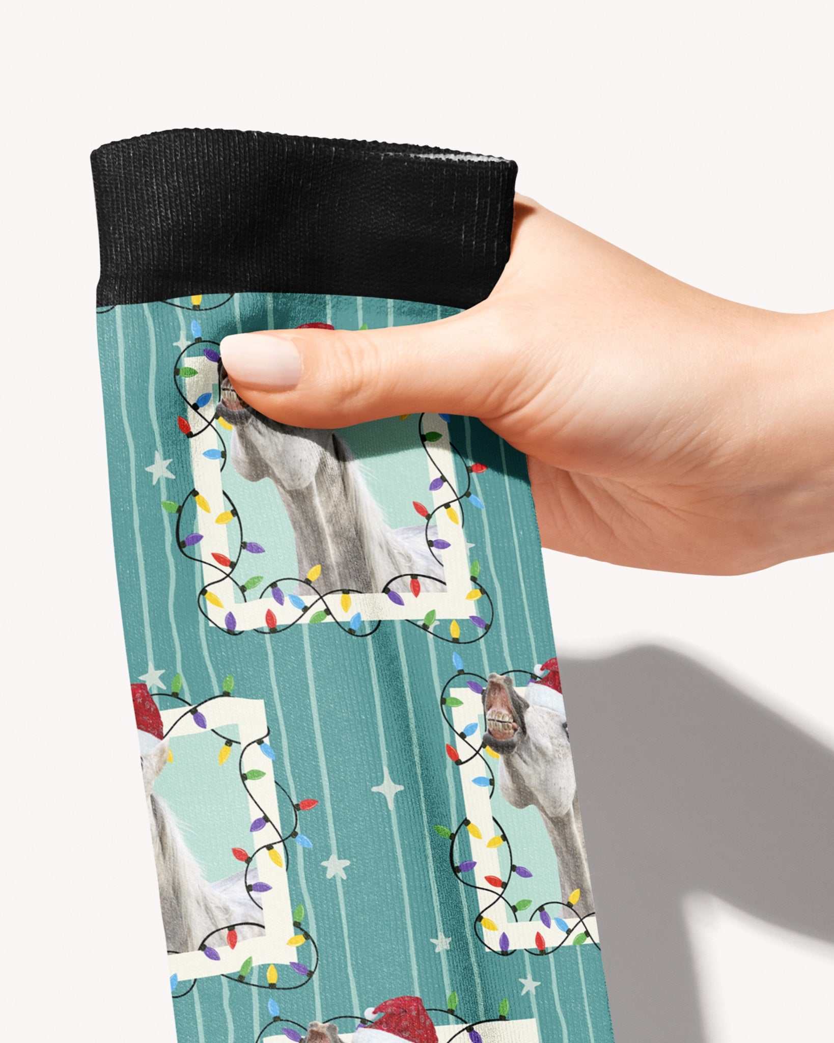 Merry & Bright custom photo equestrian boot socks, held in hand, close-up of the string-light frame pattern, by Dreamers & Schemers