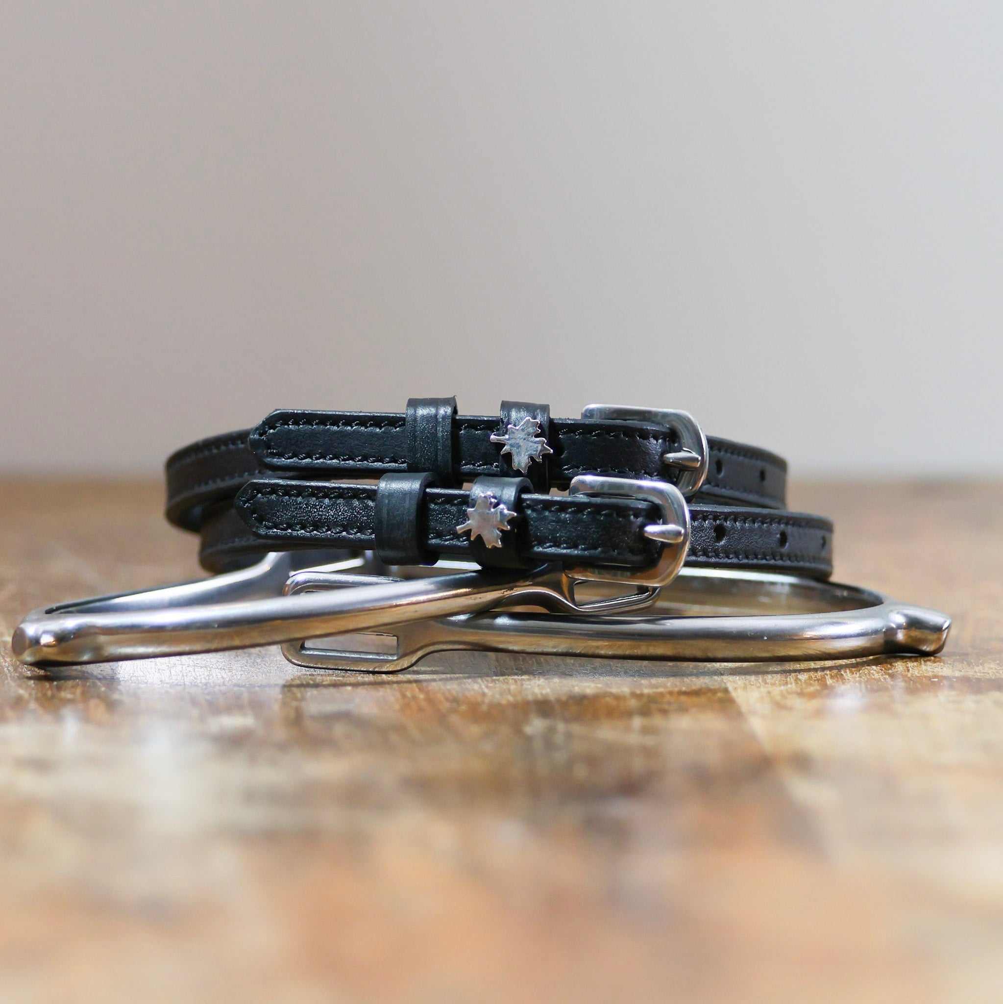 ManeJane Canada Spur Straps (maple leaf) Spur Straps — black leather, non-stretch, hero image for English riders.