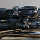 Black More Leg Spur Straps with stainless steel buckles and custom star-shaped charms on premium leather
