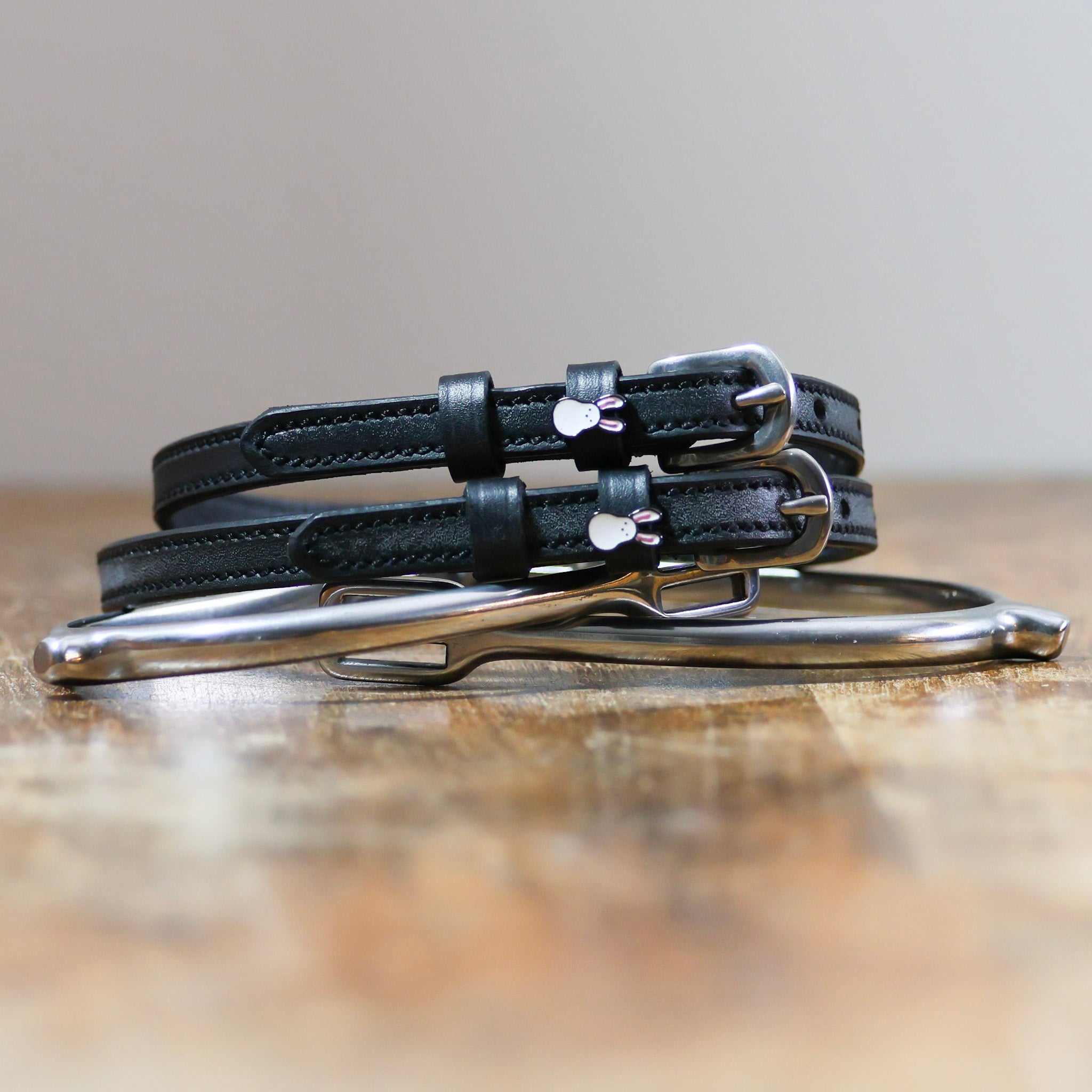 ManeJane Bunny Hop Spur Straps Spur Straps — black leather, non-stretch, hero image for English riders.