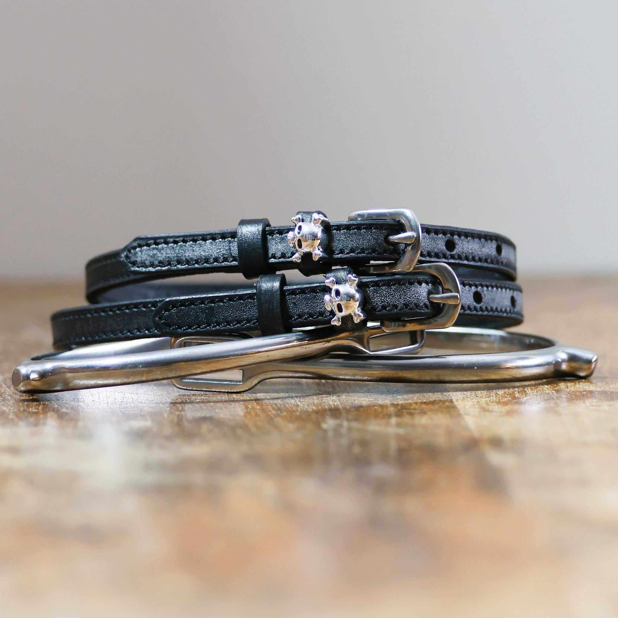 ManeJane Skull & Crossbones Spur Straps Spur Straps — black leather, non-stretch, hero image for English riders.