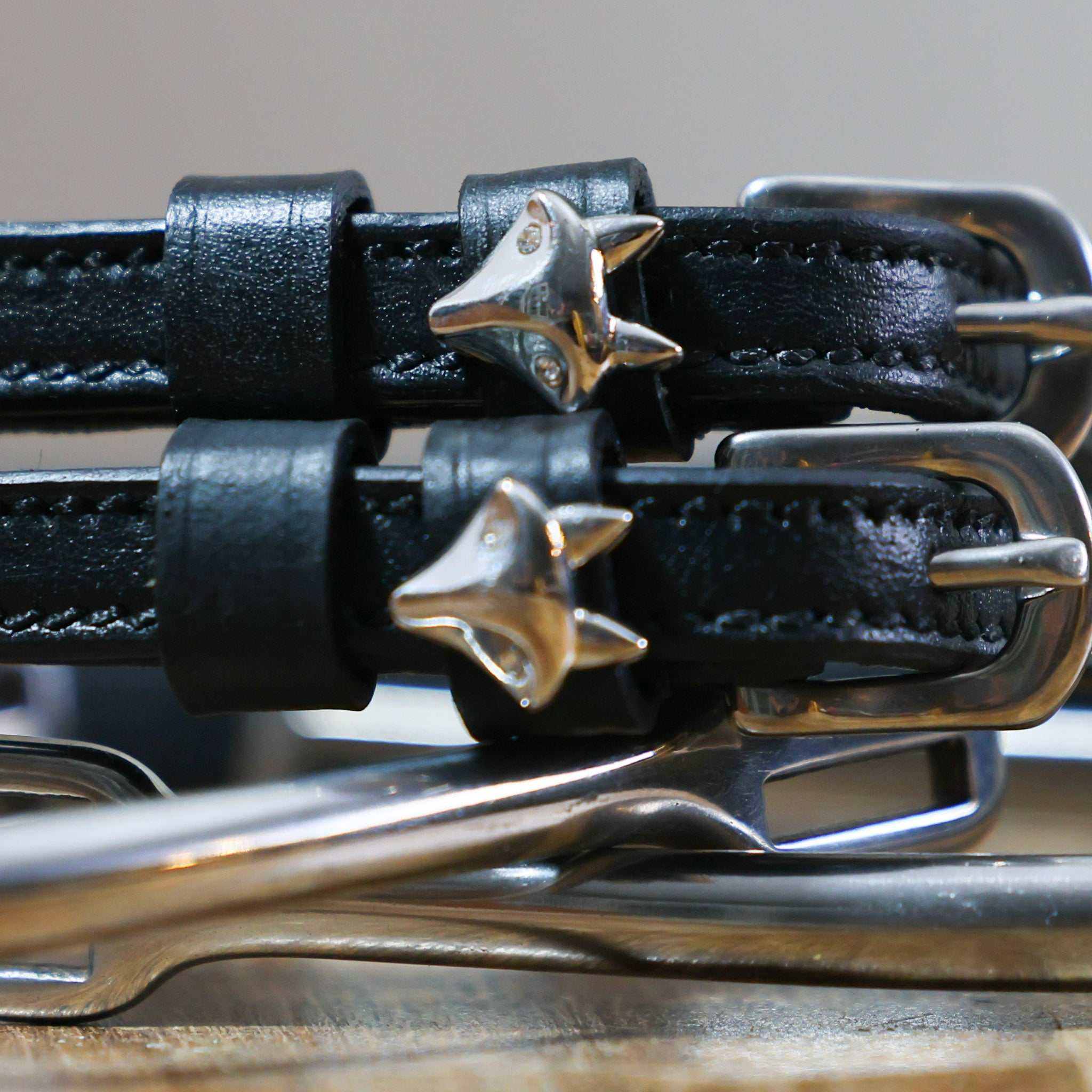 Silver Fox Spur Straps black leather with stainless steel buckles and custom fox charm close-up