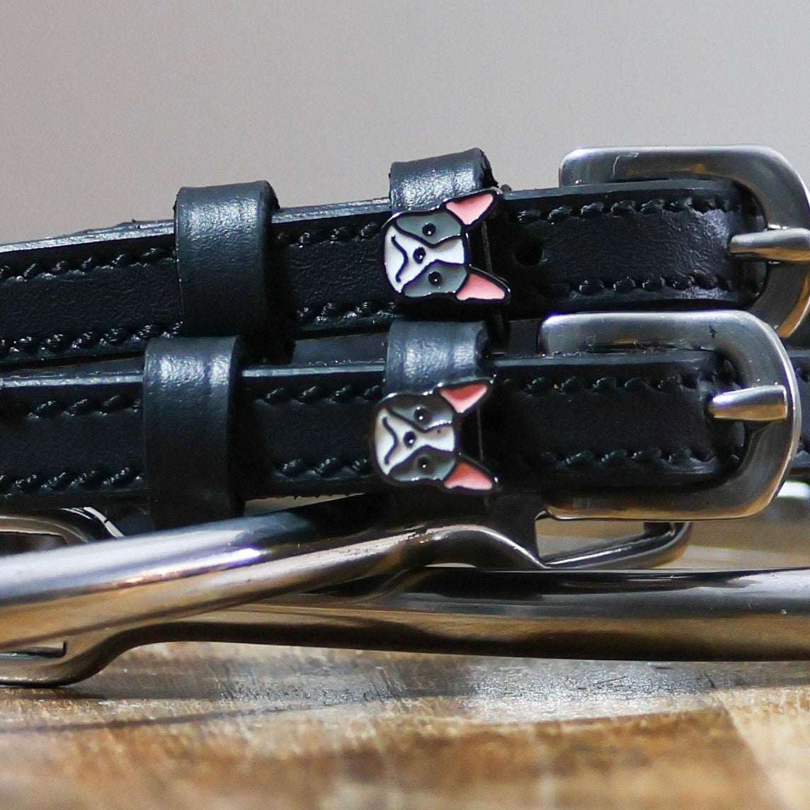 Black leather spur straps with stainless steel buckles and Frenchie dog charms