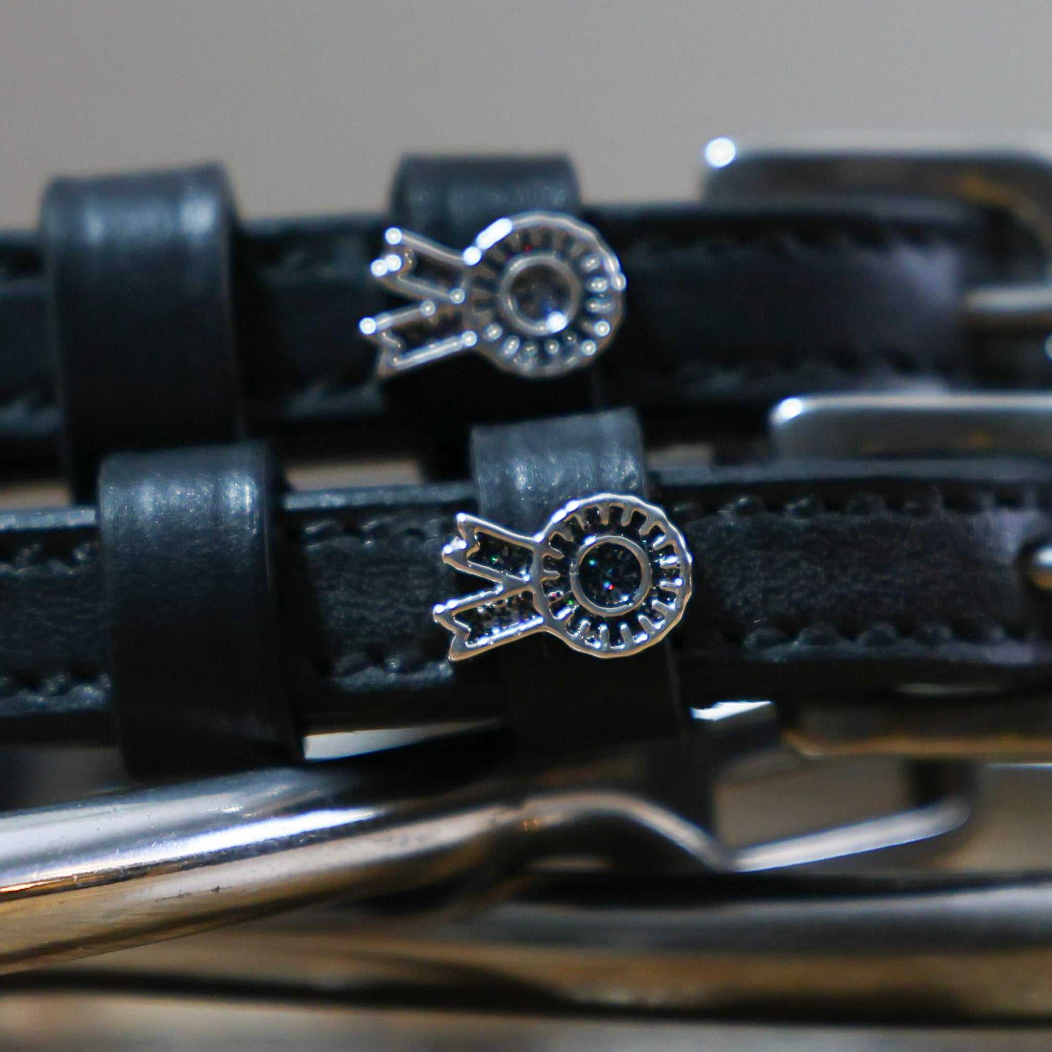 Rosette Spur Straps black leather with stainless steel buckles and custom floral charm close-up