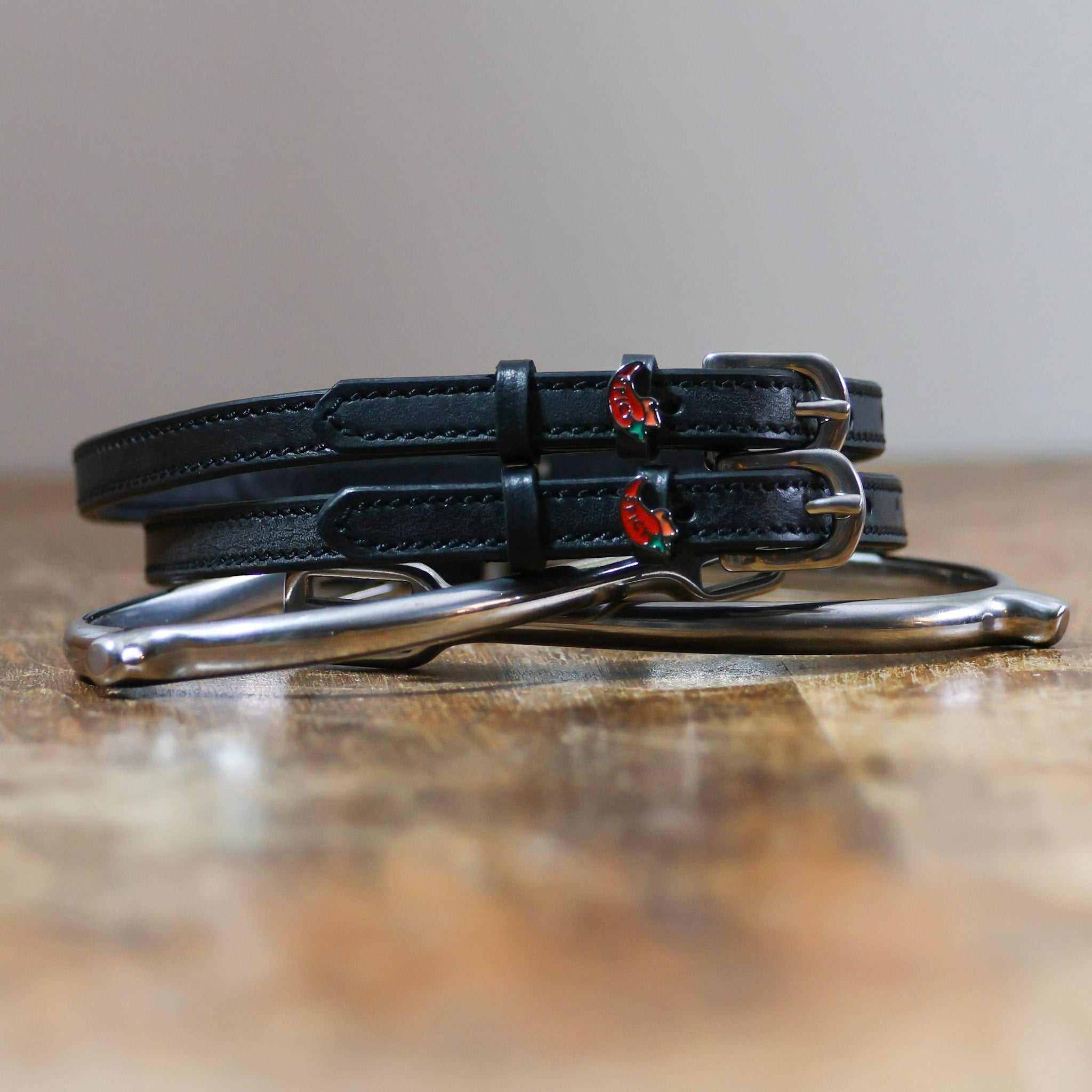 ManeJane Spicy Pepper Spur Straps Spur Straps — black leather, non-stretch, hero image for English riders.