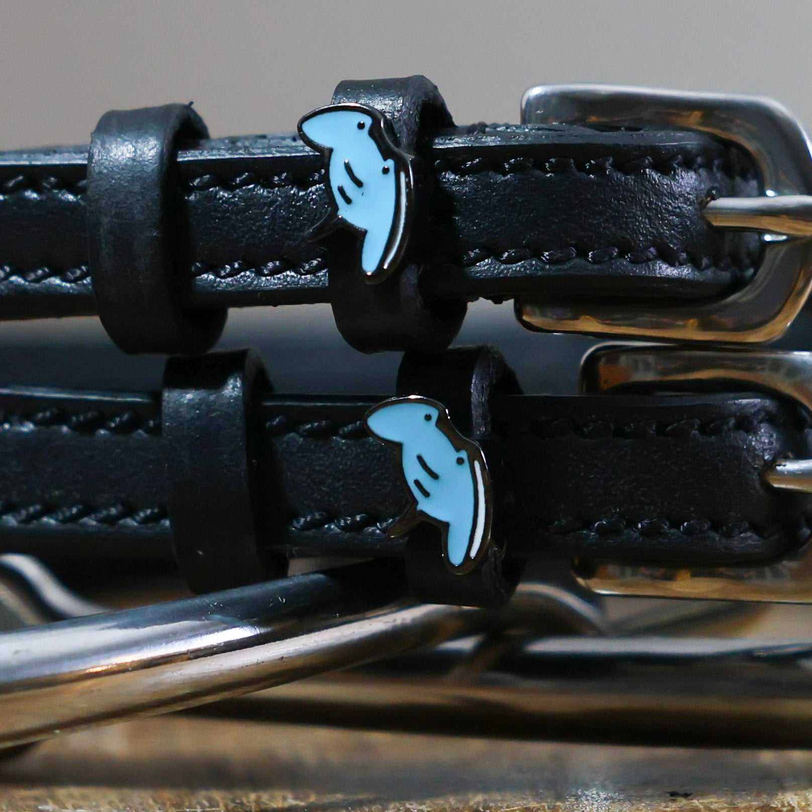 Black stingray spur straps with stainless steel buckles and custom blue stingray charms